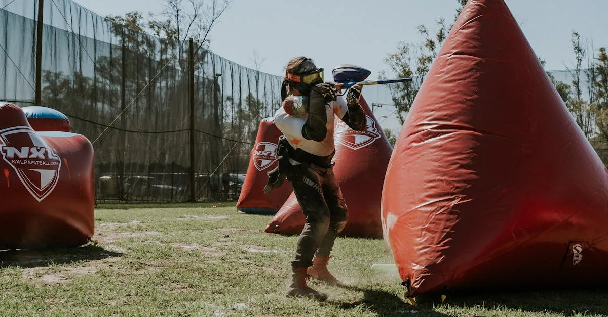 Player aiming a fast-firing speedball gun during an inflatable bunker tournament match