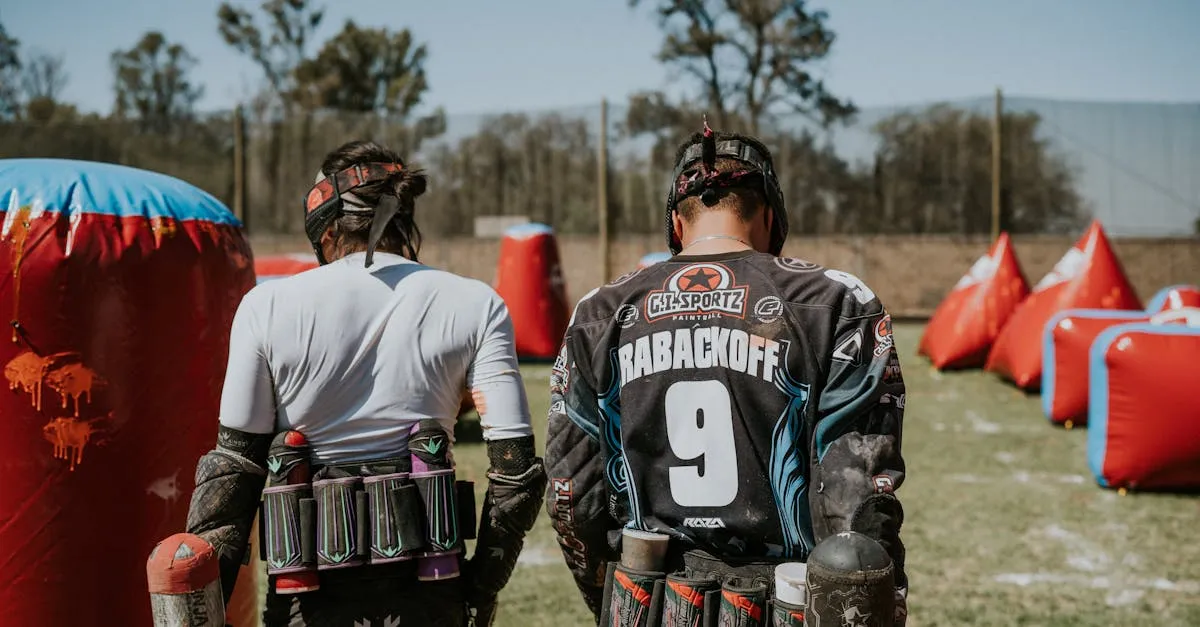 Two players in action on a paintball field, equipped and ready for the game.