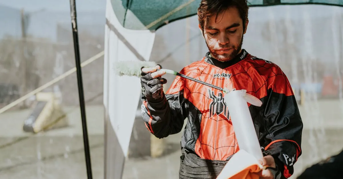 Player outdoors disassembling and cleaning a paintball gun for routine maintenance