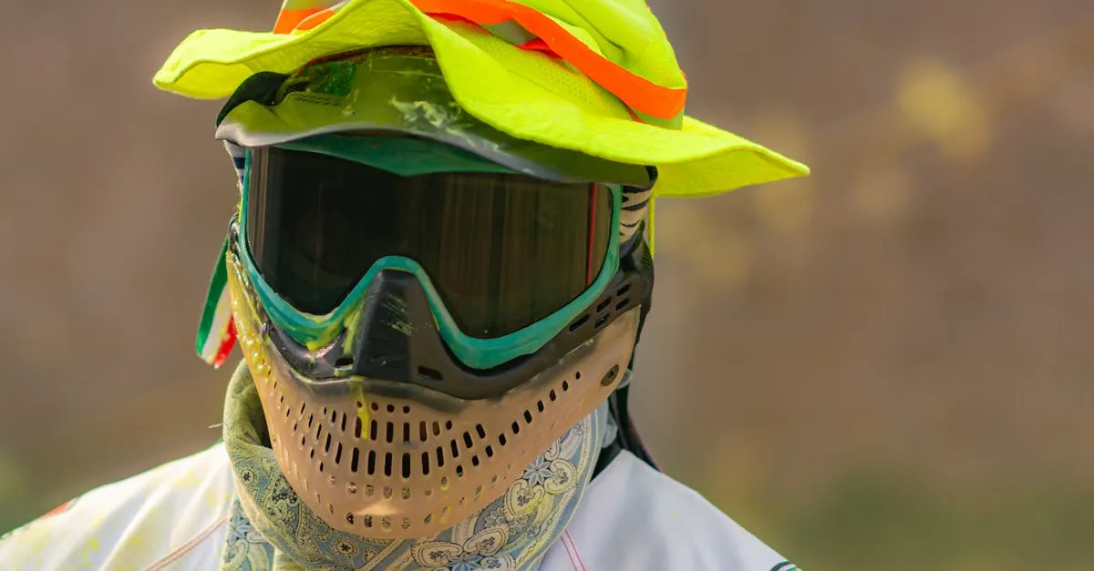 Player wearing full protective mask and safety gear demonstrating paintball safety equipment