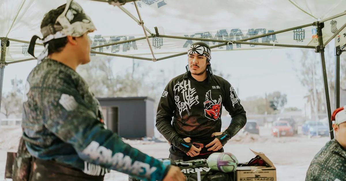 Paintball team in full gear preparing under a staging tent before a major tournament