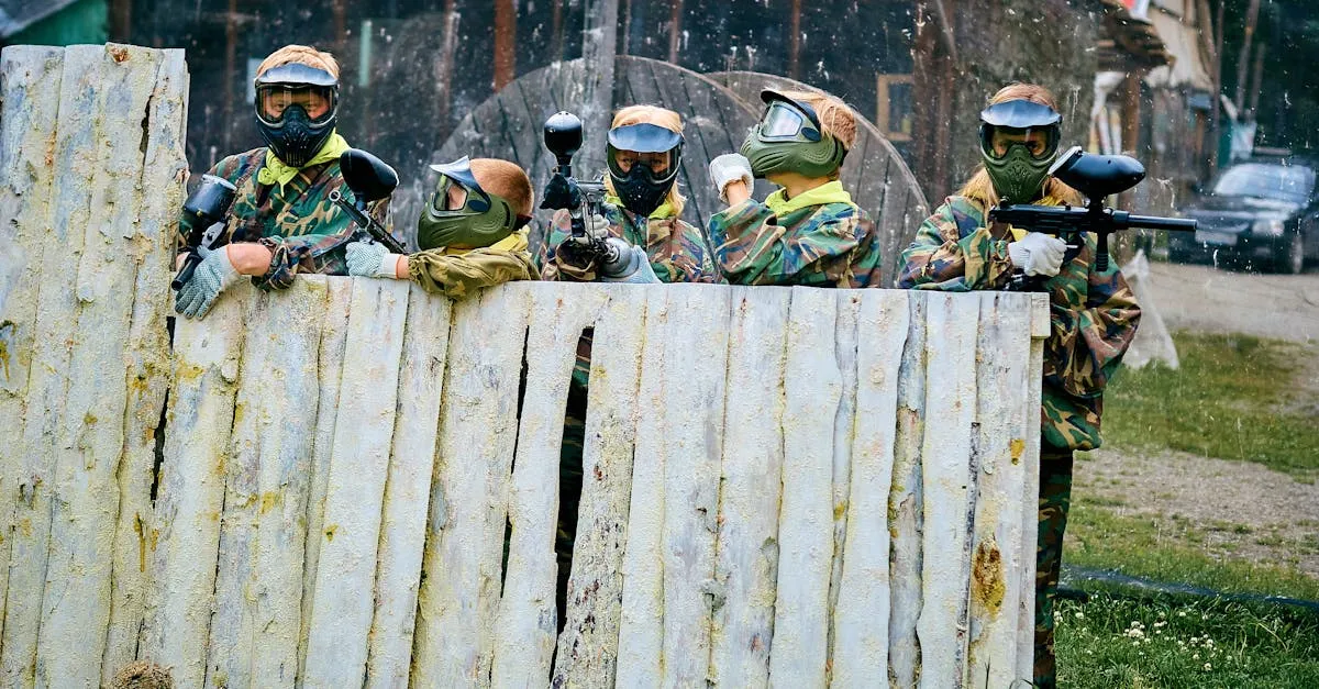 Players aiming over a fence with top brand markers from the best paintball gun manufacturers