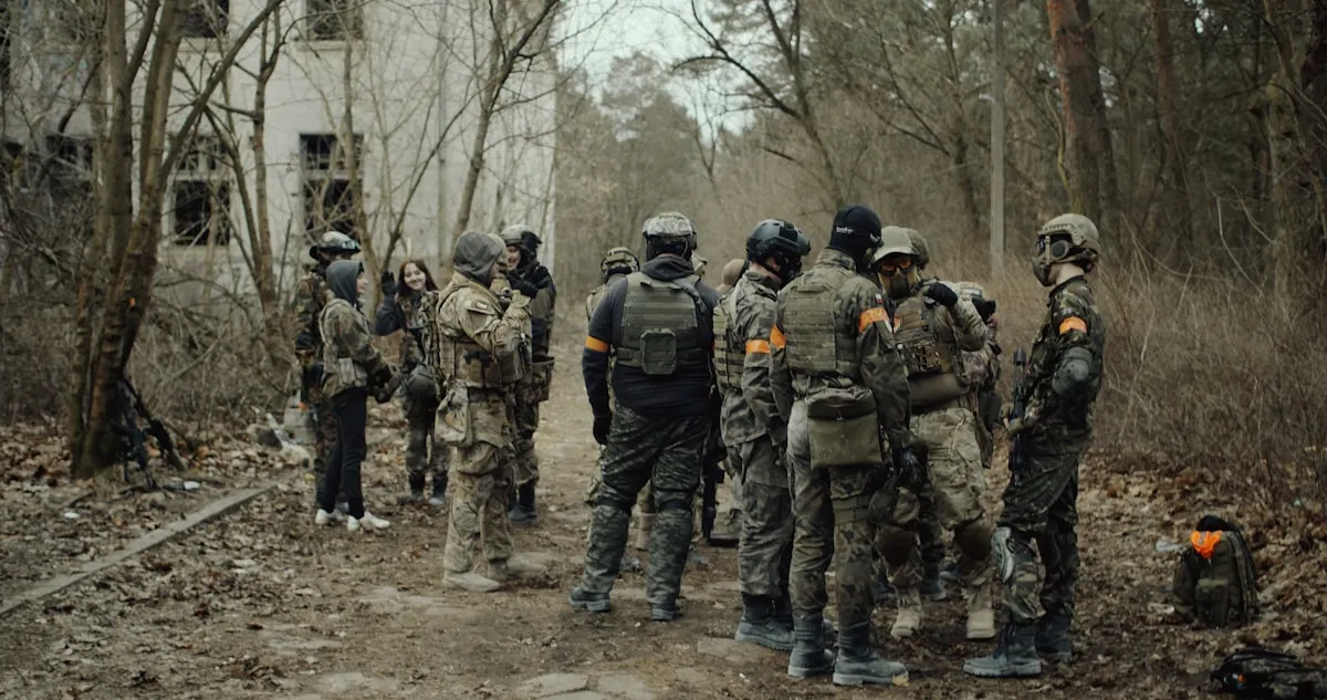 layered paintball clothing with base layer, long sleeve shirt, and cargo pants