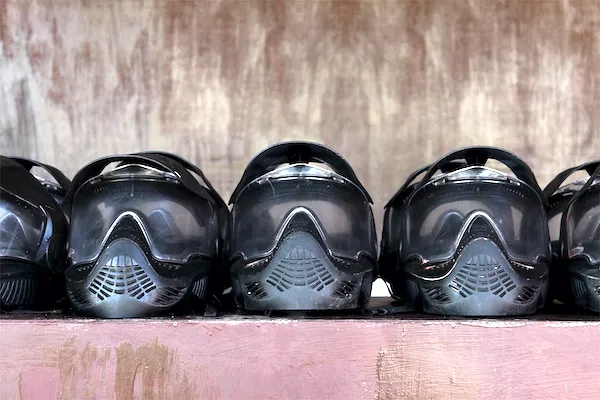 several paintball masks lined up on a table